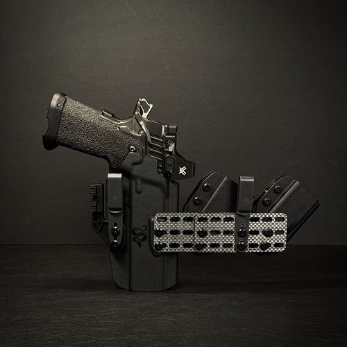 DoubleMagCarrierIWBNL - Superstition Concealment Semi-automatic handgun mounted in a black tactical holster with magazine pouches on a dark background.