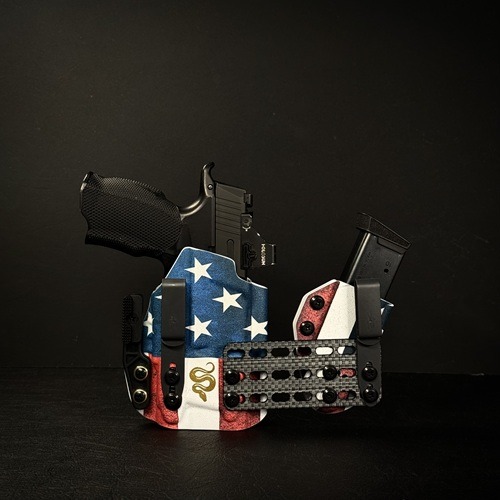 Patriotic gun holster with a black handgun showing above it.