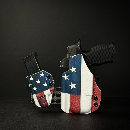 Two handguns in star-spangled holsters posed against a dark background, emphasizing patriotic design.
